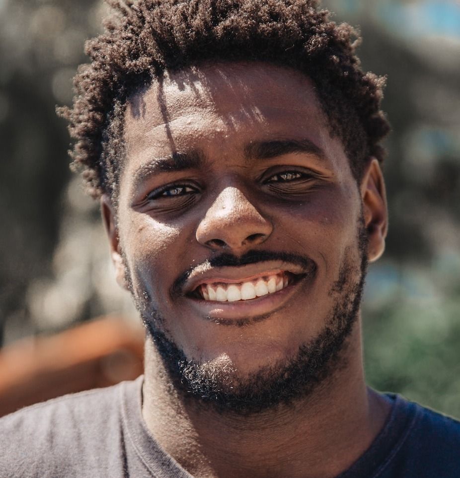 selective focus of man smiling during daytime