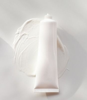 a tube of cream sitting on top of a white plate