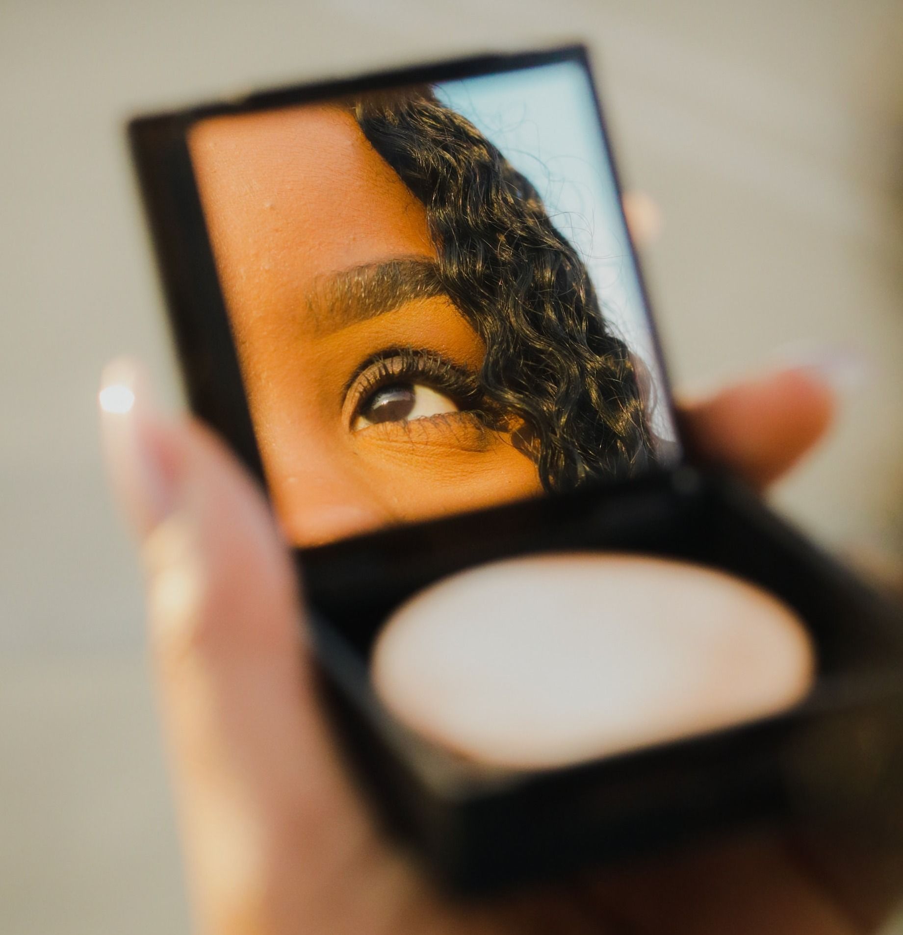 a woman holding a compact compact compact compact compact compact compact compact compact compact compact compact - Acne Scars