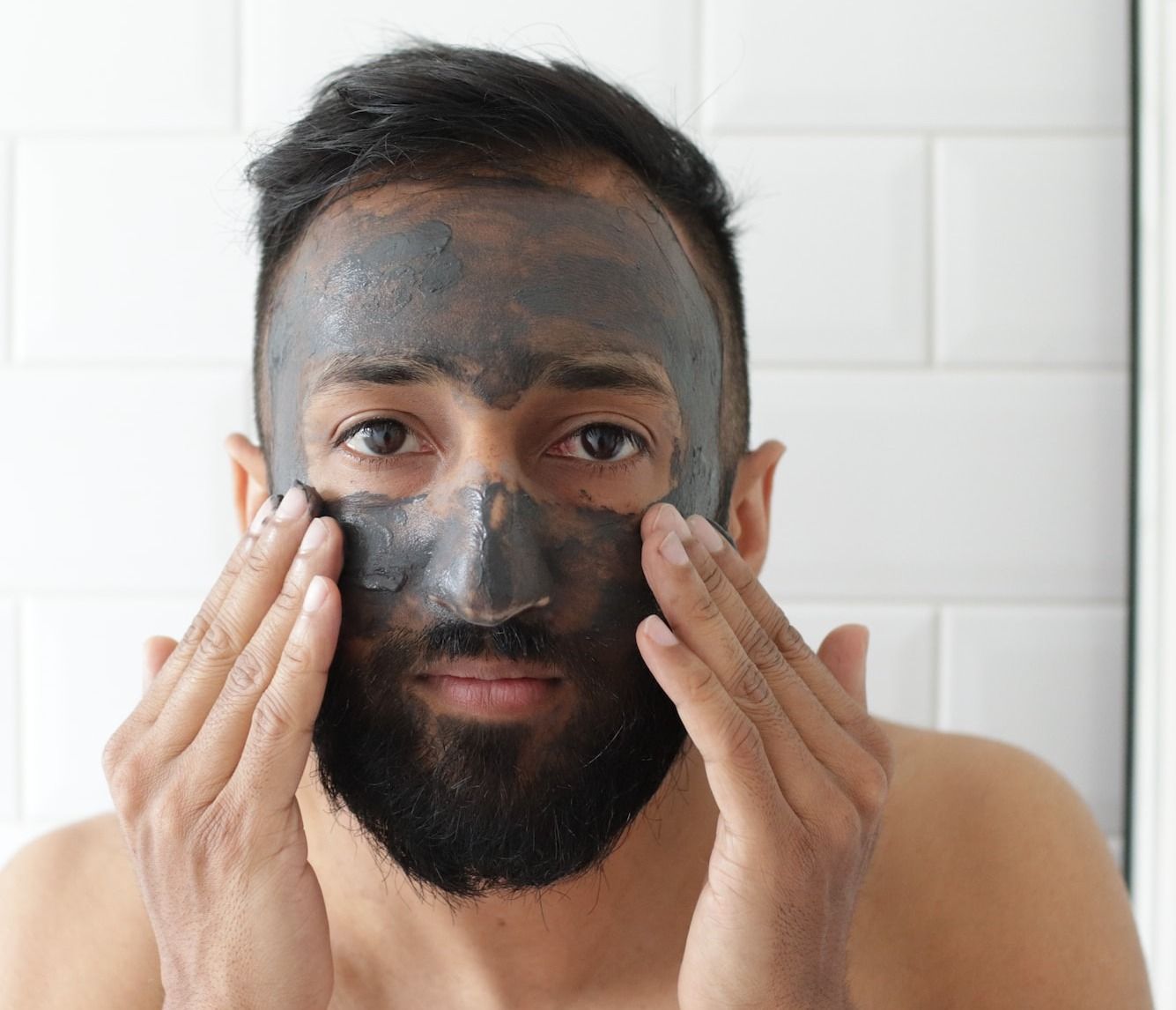 topless man covering face with white powder men's skincare gifts sets