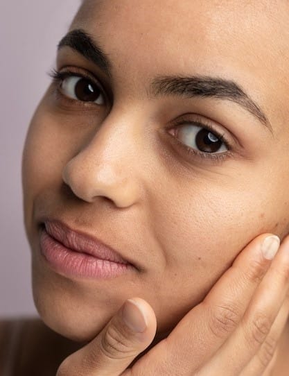 Free photo close up of girl with hand over face with skin pores during face care routine - Alpha Hydroxy Acid Skincare