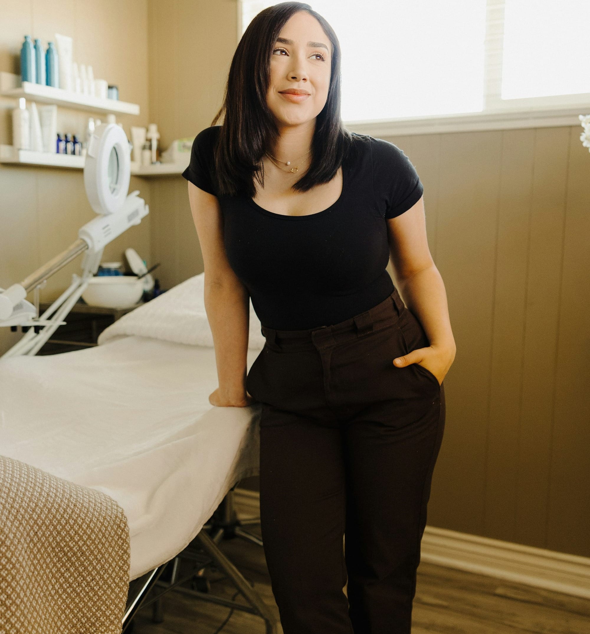 a woman standing next to a bed in a room - AHAs and BHAs for acne prone skin