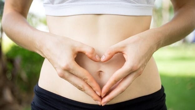 Free photo close-up of female hands shaping heart on belly