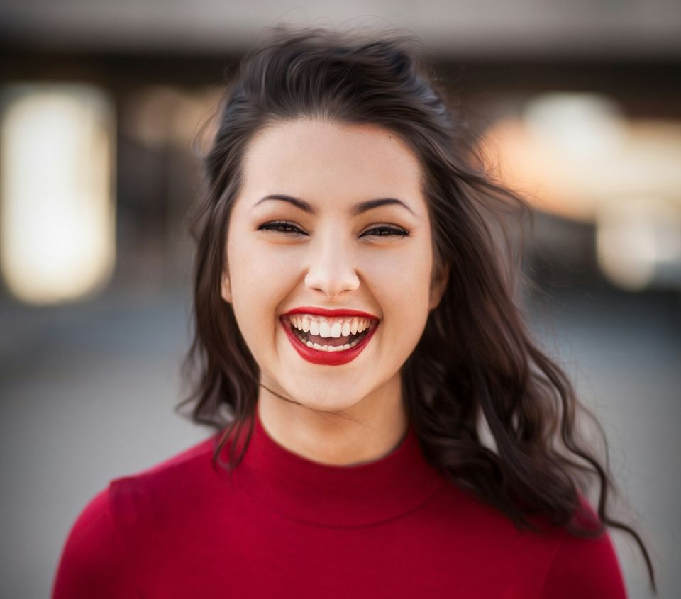 girl with long black hair and red polo neck sweater - Acne Free Skin