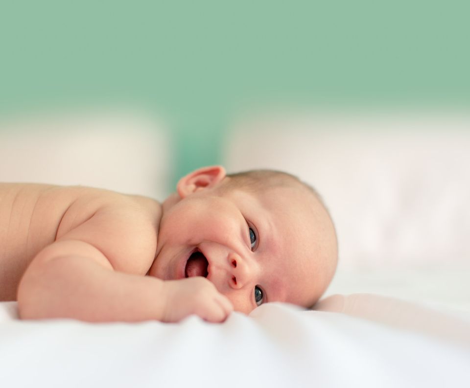 baby lying on white blanket - Acne-Prone Skin - Baby Acne