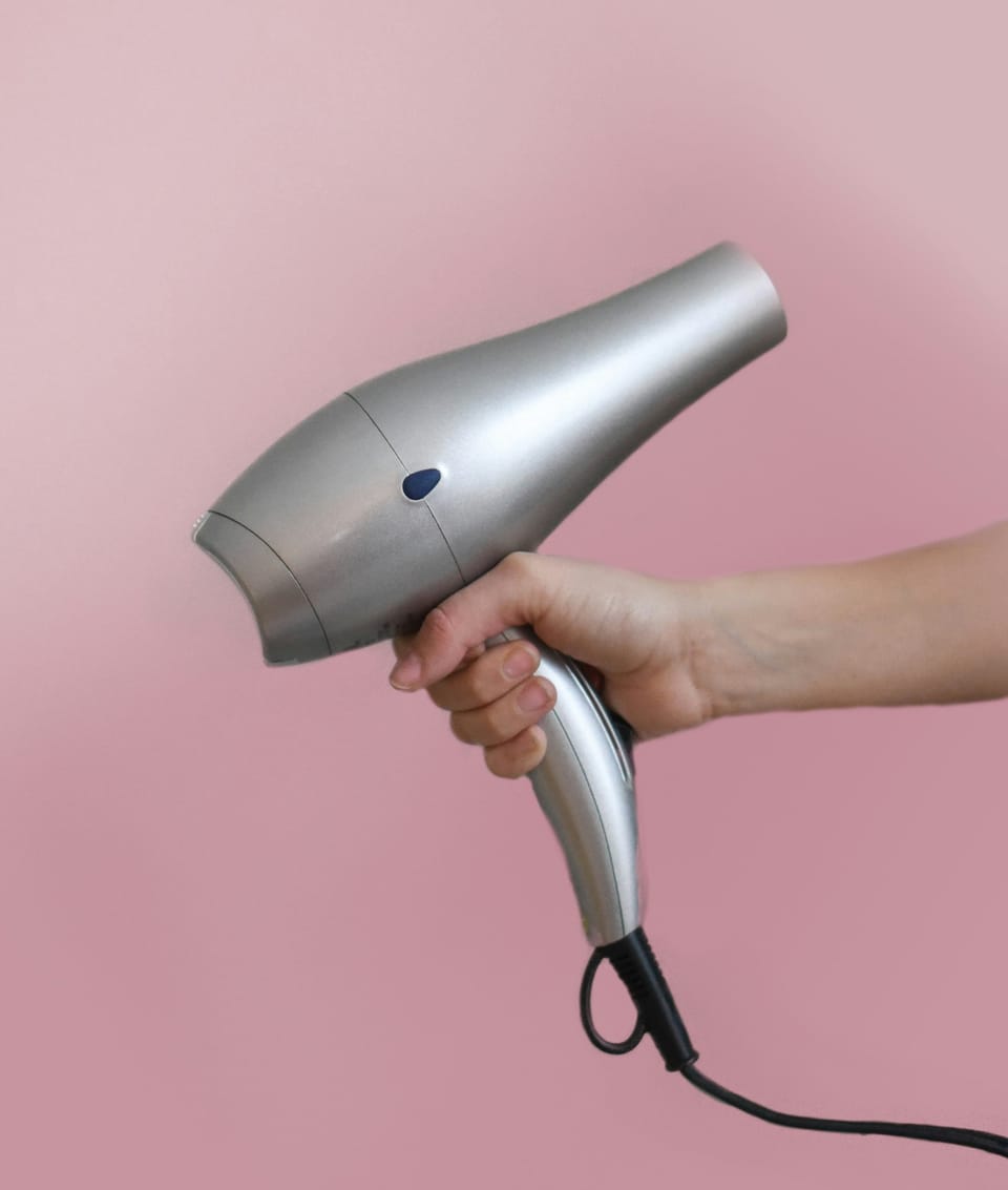 Hair Dryer held in someones hand - Best Hair Dryers