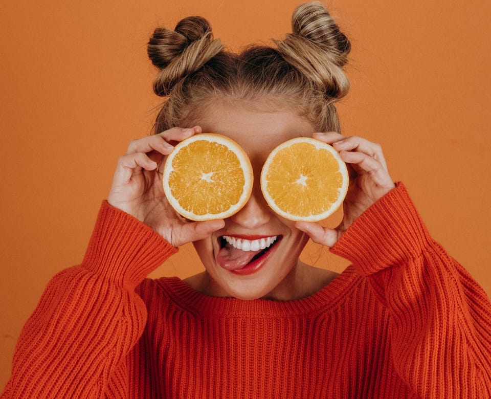 girl with orange sweater - Best Vitamin C Serums