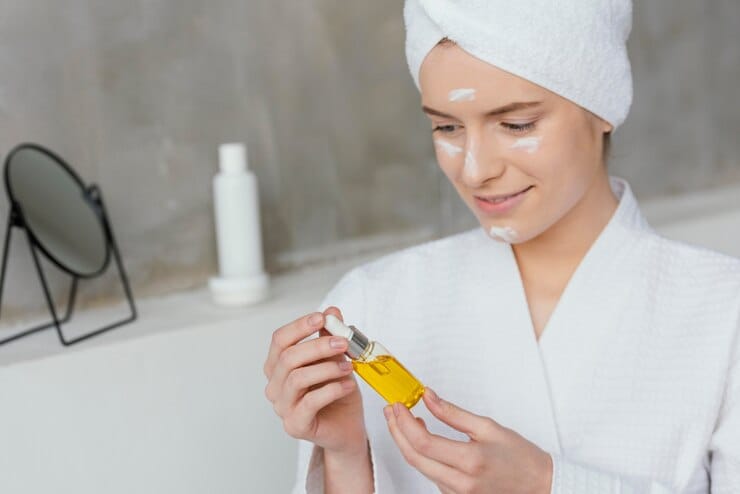 woman-having-self-care-routine_23-2148976840 - holding glass bottle of oil