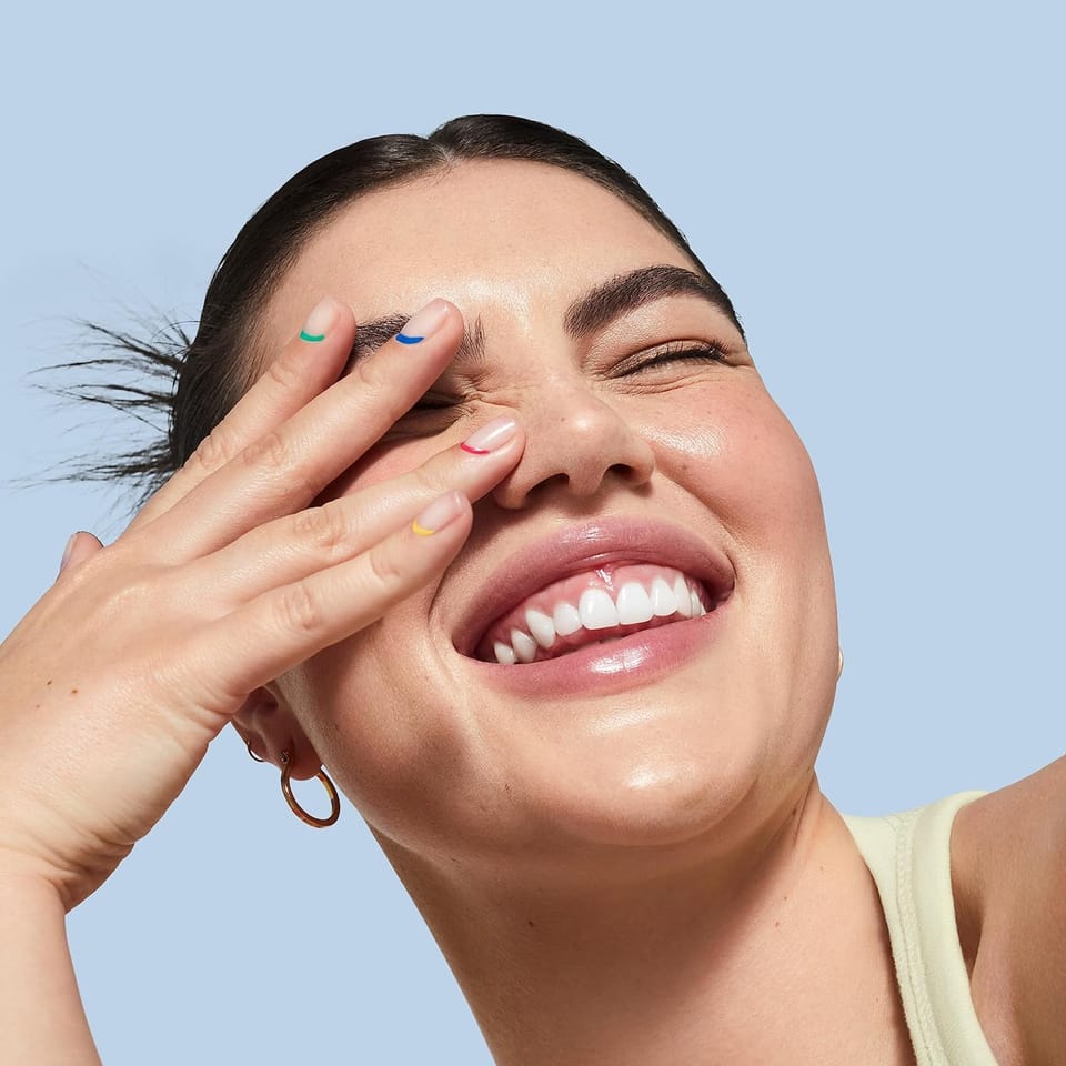 Laughing girl covering her eyes with her hands