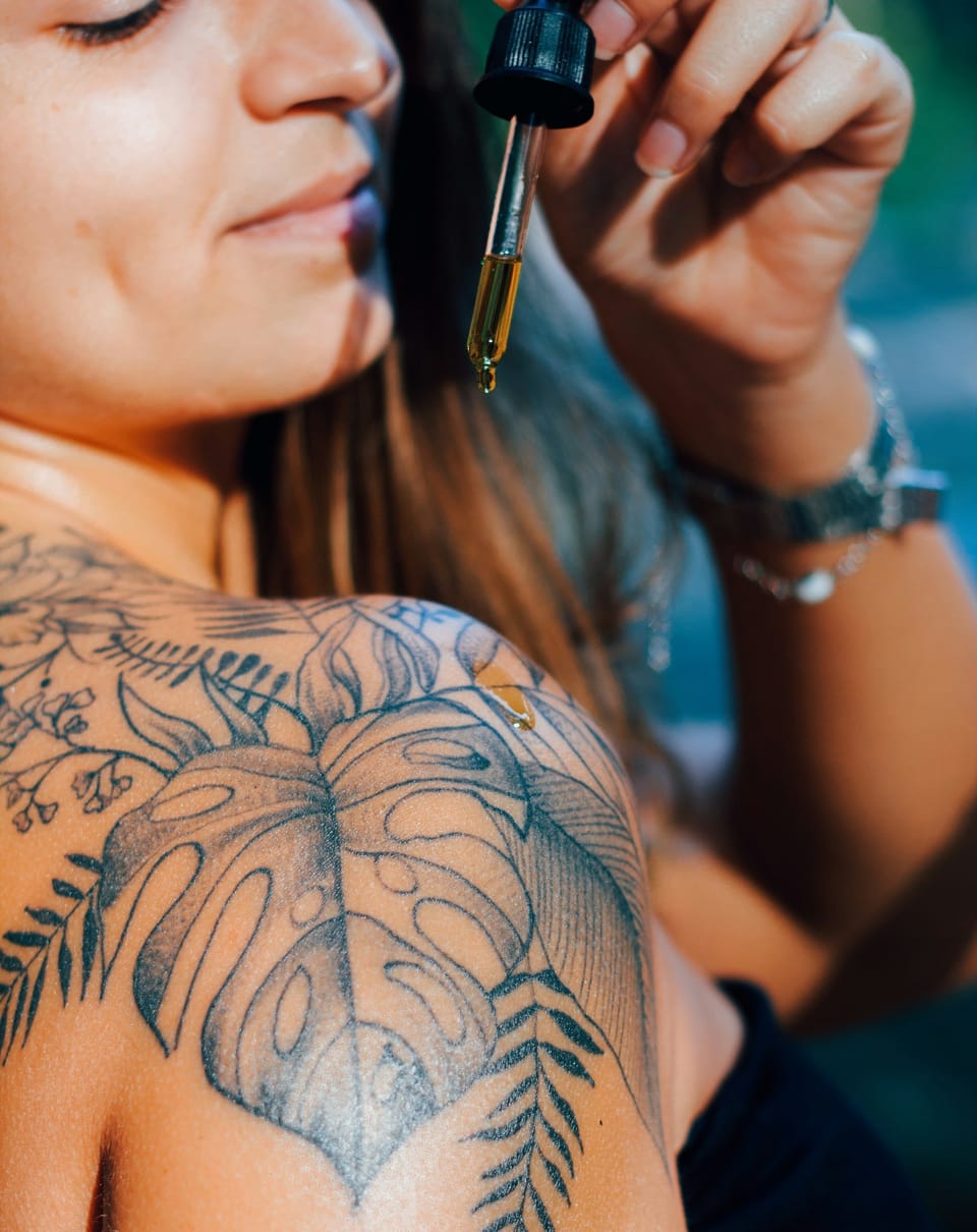 girl with leaf tattoo on shoulder - Best Body Oils 